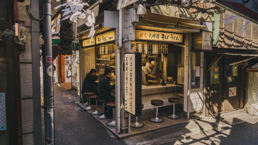 Men sit at the bar of a ramen shop in Japan