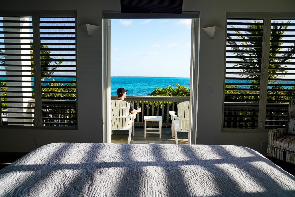 man drinks coffee on balcony in Turks and Caicos