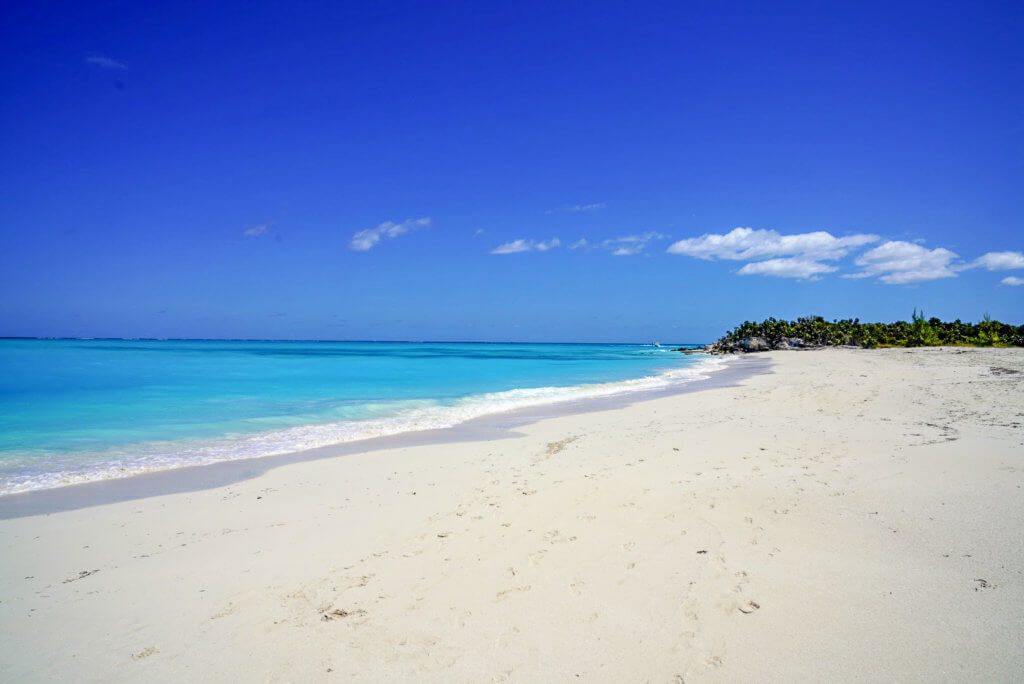 white sand beach and blue ocean and sky in the caribbean