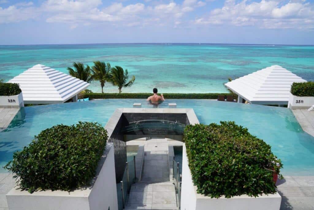 man in infinity pool at tc villas turks and caicos