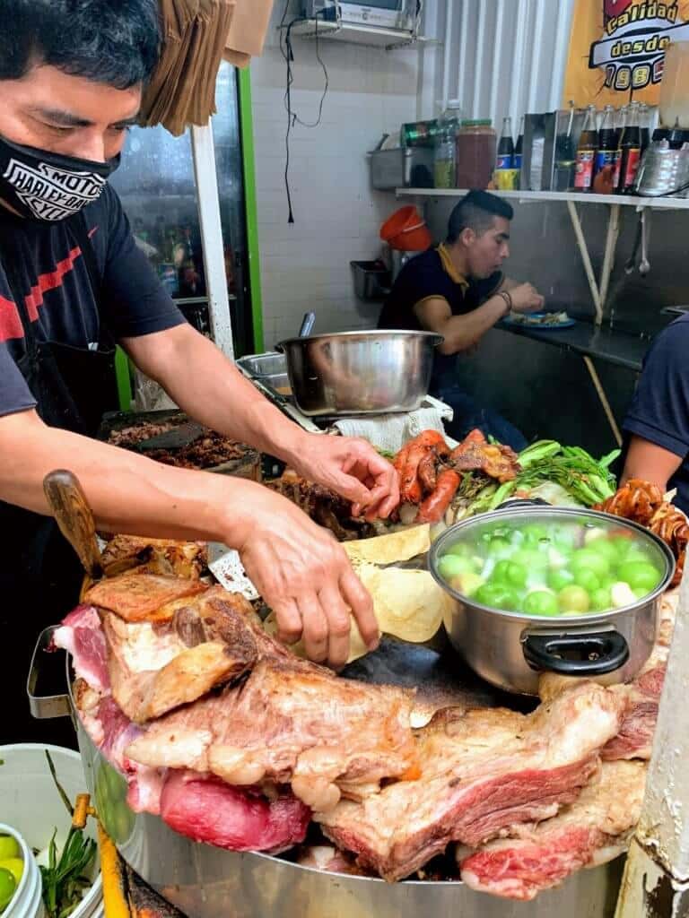 a man makes street food in mexico city
