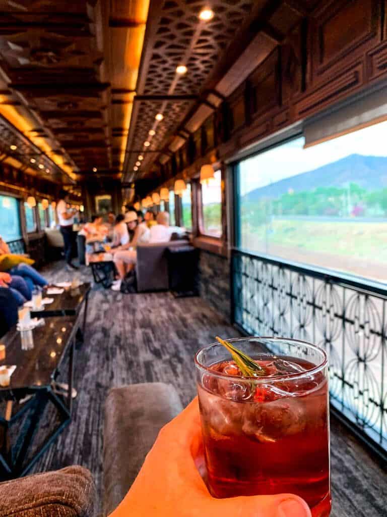 Close up view of a cocktail inside of a fancy train carriage