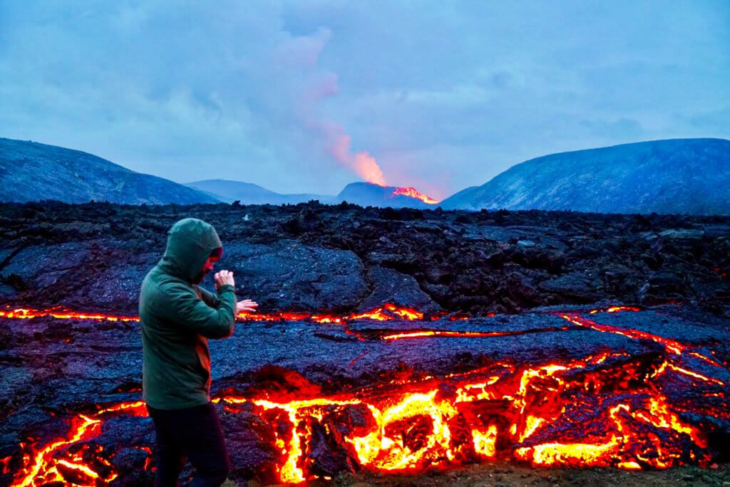 man feels the heat from lava a during visit to Fagradalsfjall volcano