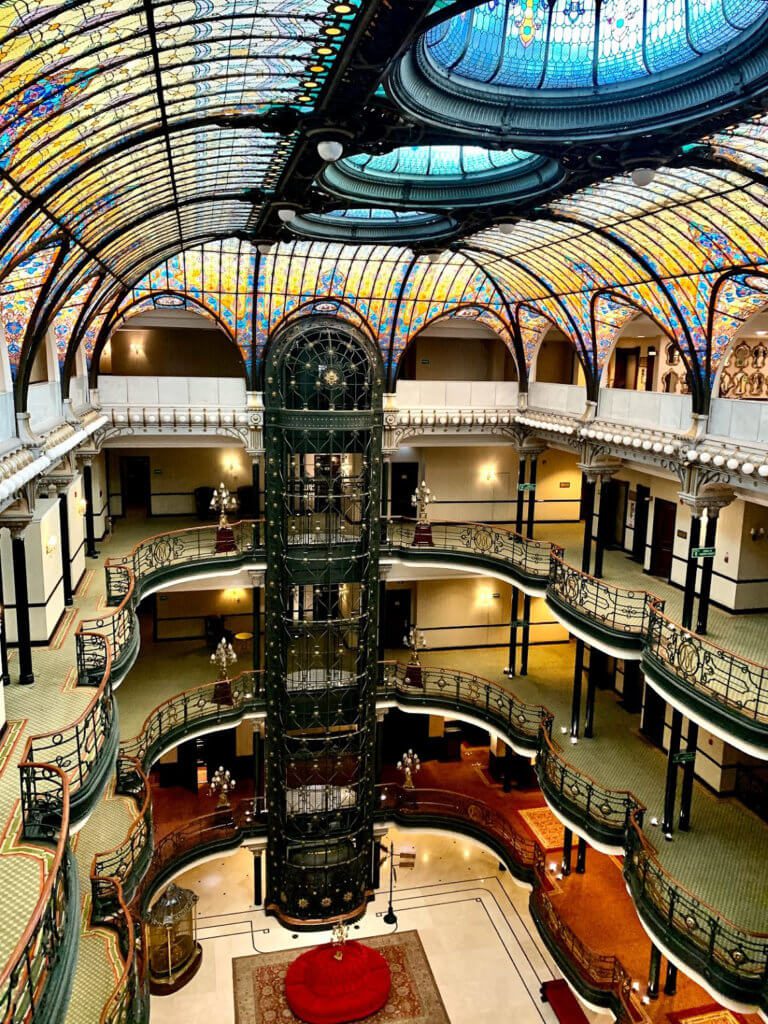tiffany stained glass ceiling and iron elevator at gran hotel de ciudad de mexico 