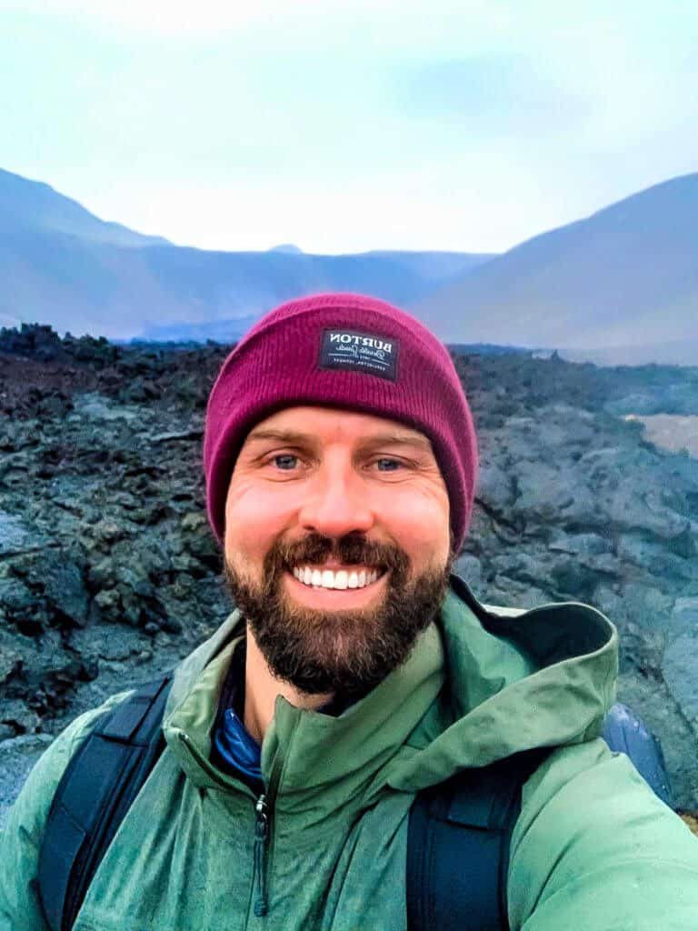 man takes selfie in front of lava in iceland 